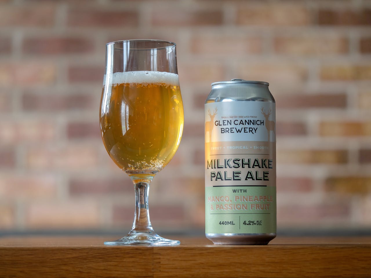 Offerings Glass and can of Glen Cannich Milkshake Pale Ale with mango, pineapple, passion fruit flavor.